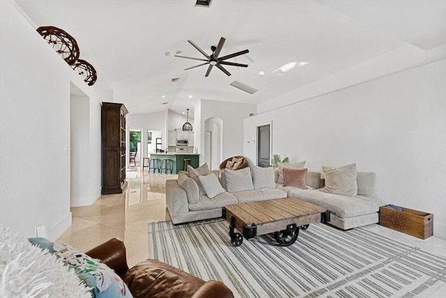 living room with ceiling fan and vaulted ceiling