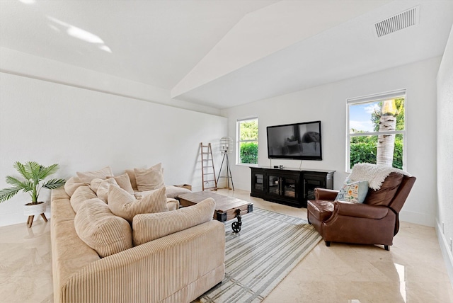 living room with vaulted ceiling and a wealth of natural light