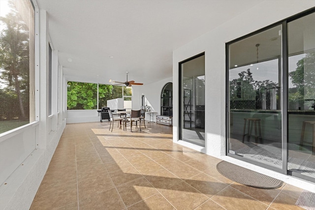 sunroom / solarium featuring ceiling fan