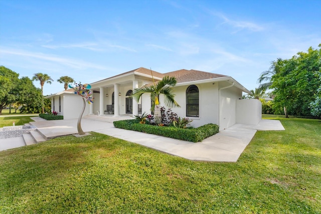 mediterranean / spanish-style home with a garage and a front yard