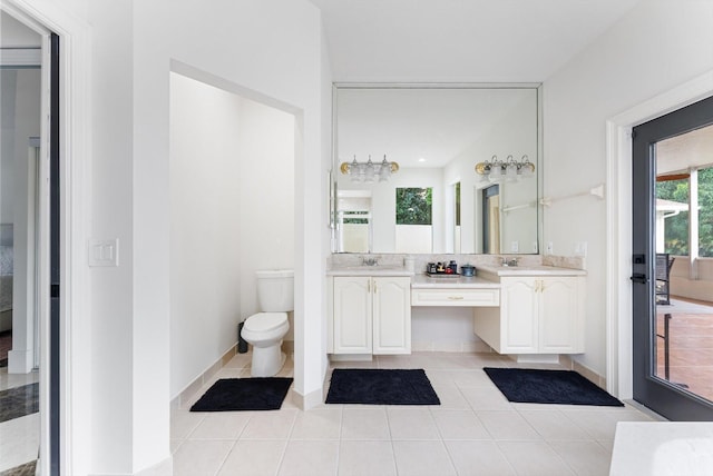 bathroom featuring tile patterned floors, vanity, and toilet