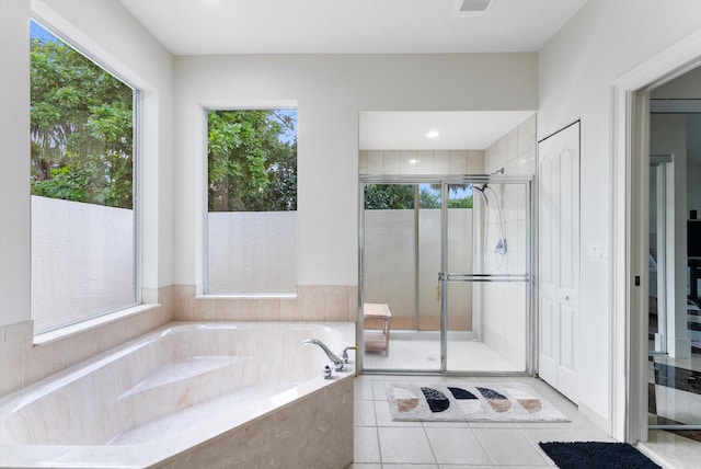 bathroom with tile patterned floors, plenty of natural light, and independent shower and bath