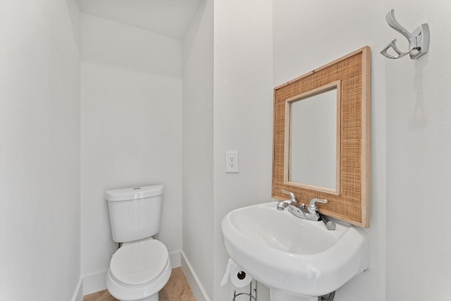 bathroom with tile patterned floors, toilet, and sink