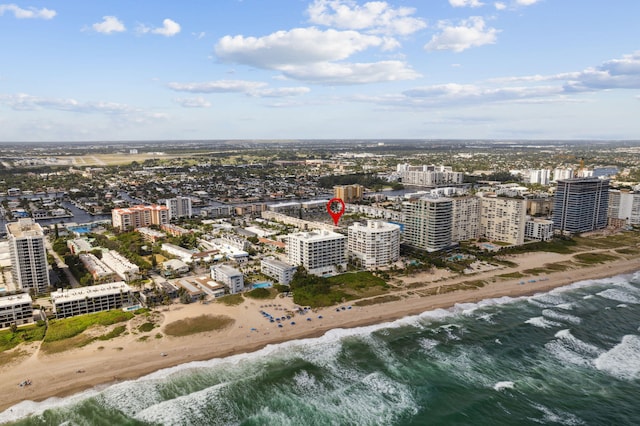 birds eye view of property with a beach view and a water view