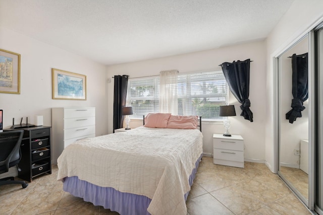 bedroom featuring a textured ceiling and light tile patterned floors