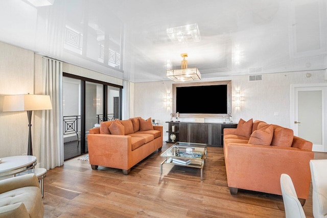 living room with high vaulted ceiling and light wood-type flooring