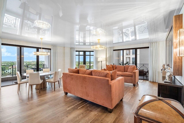 living room with hardwood / wood-style floors and a high ceiling