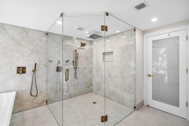 bathroom featuring a shower with shower door