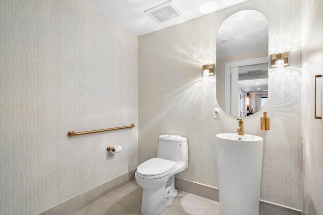 bathroom featuring tile patterned flooring and toilet