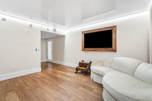 living room featuring a high ceiling and light wood-type flooring