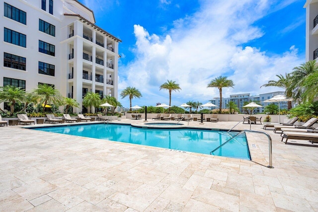 view of pool with a community hot tub and a patio