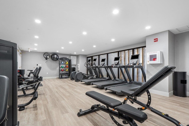 exercise room featuring light wood-type flooring