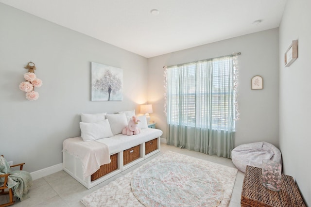 living area with light tile patterned floors and baseboards