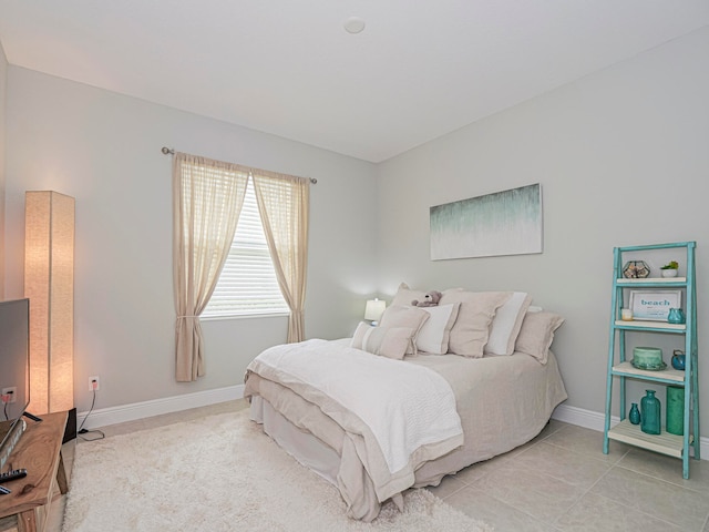 bedroom with light tile patterned floors