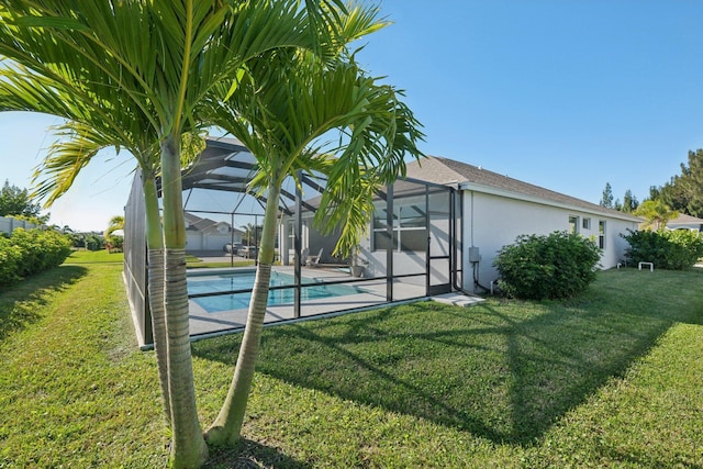 pool featuring a lawn and a lanai