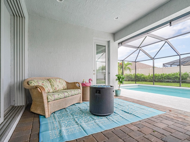 view of swimming pool with glass enclosure and a patio area