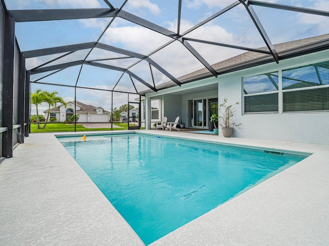 view of swimming pool with a patio and a lanai