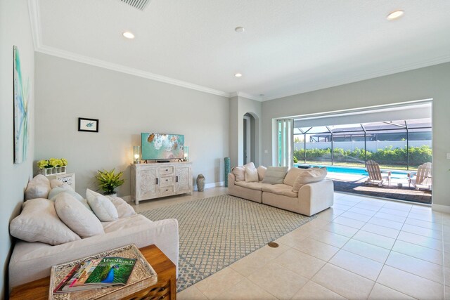 entryway with ornamental molding, a wealth of natural light, and light tile patterned floors