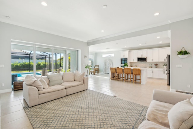 living room featuring light tile patterned floors, baseboards, recessed lighting, a sunroom, and crown molding