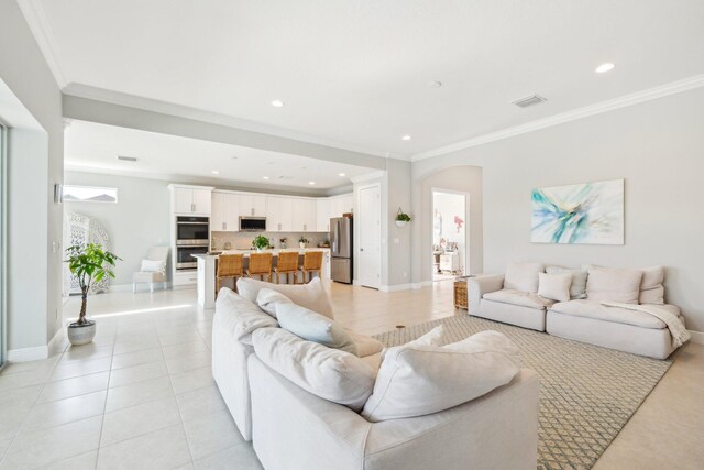 living room featuring light tile patterned flooring and ornamental molding