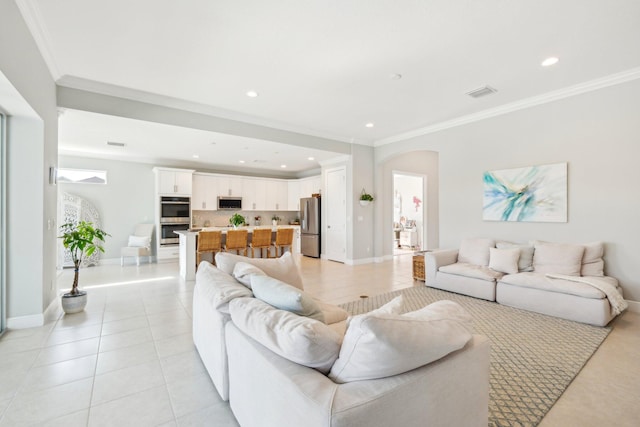 living room featuring light tile patterned floors, visible vents, ornamental molding, and recessed lighting