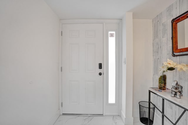 entryway featuring wood walls