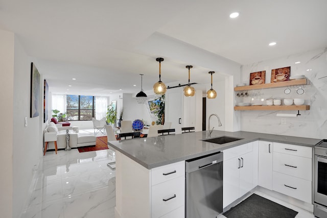 kitchen featuring kitchen peninsula, white cabinetry, sink, and stainless steel appliances