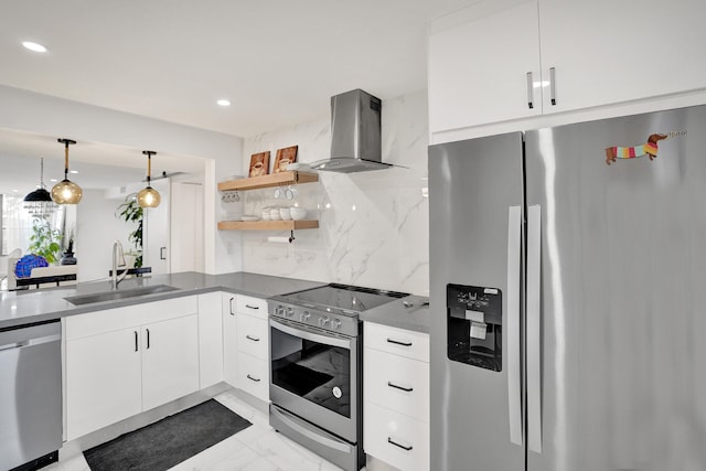 kitchen with white cabinets, wall chimney range hood, sink, hanging light fixtures, and stainless steel appliances