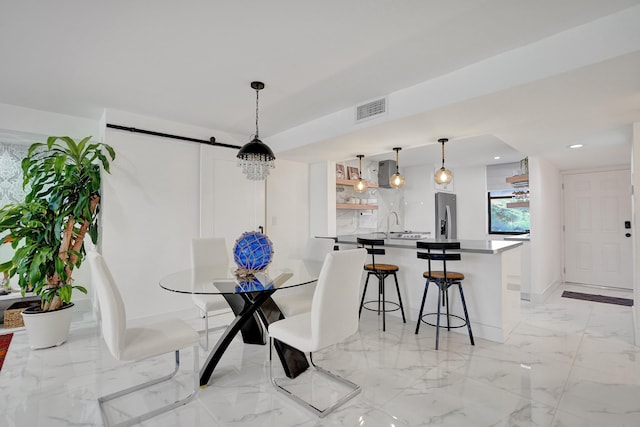 dining area featuring a barn door