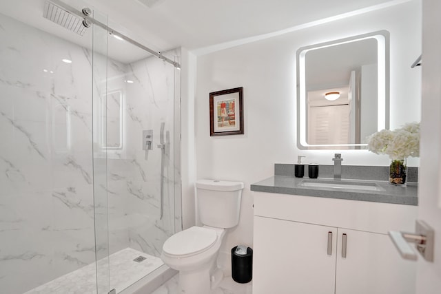 bathroom with walk in shower, vanity, and toilet