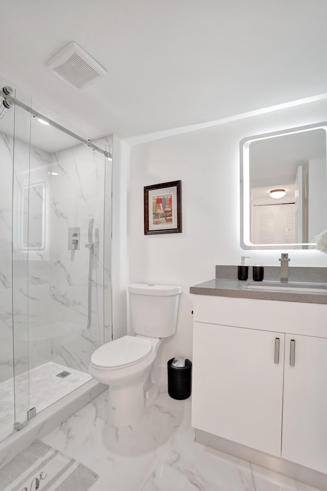 bathroom featuring vanity, an enclosed shower, and toilet