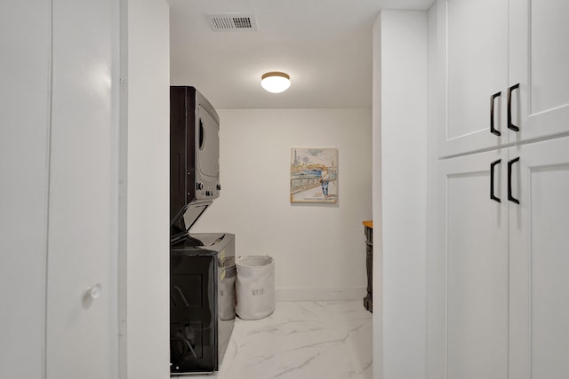 laundry area with stacked washing maching and dryer