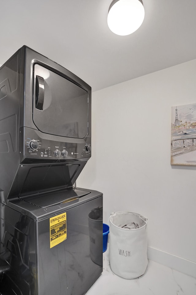 laundry area featuring stacked washer / drying machine