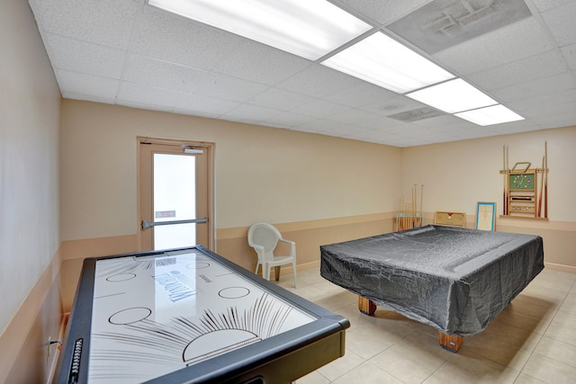 recreation room featuring a paneled ceiling, light tile patterned floors, and pool table