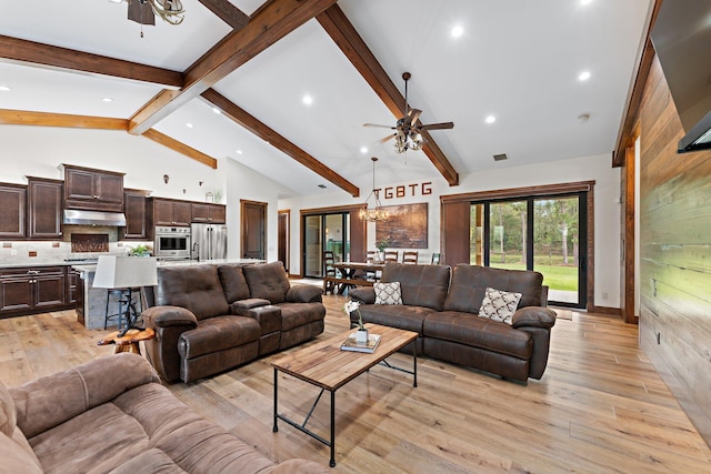 living room with ceiling fan with notable chandelier, beam ceiling, light wood-type flooring, and high vaulted ceiling