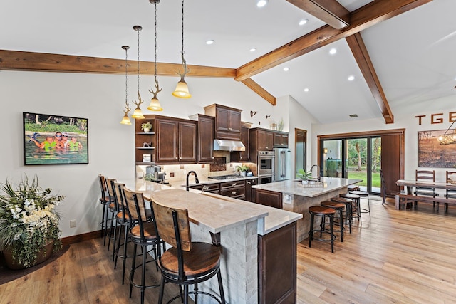 kitchen featuring kitchen peninsula, a kitchen breakfast bar, decorative backsplash, and hanging light fixtures