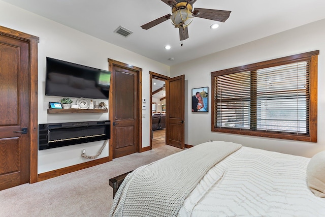 bedroom featuring ceiling fan and light carpet