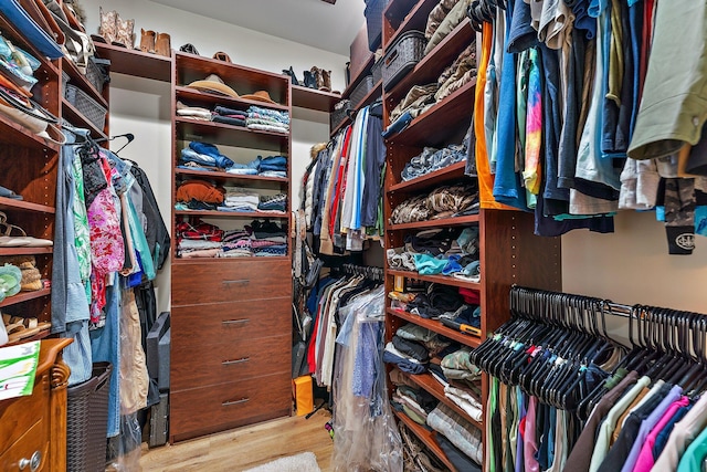 spacious closet featuring light hardwood / wood-style floors