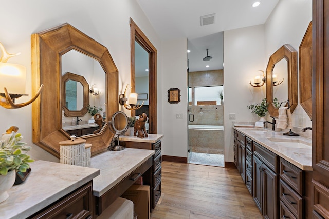 bathroom with plus walk in shower, vanity, and hardwood / wood-style flooring