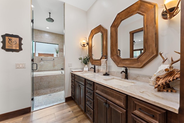 bathroom featuring vanity, wood-type flooring, and independent shower and bath