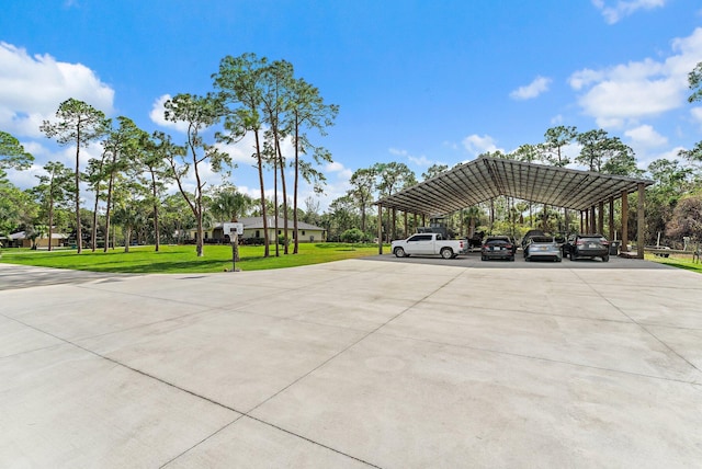 view of parking featuring a carport and a yard