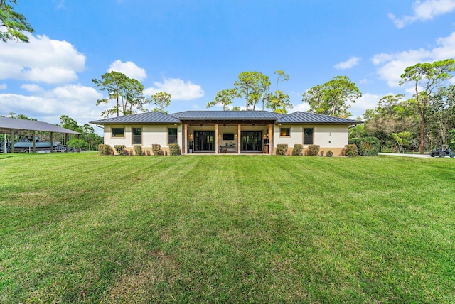 rear view of property with a yard