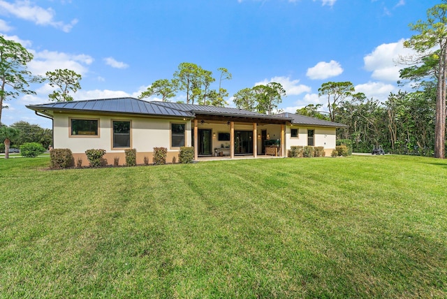 back of house with a lawn