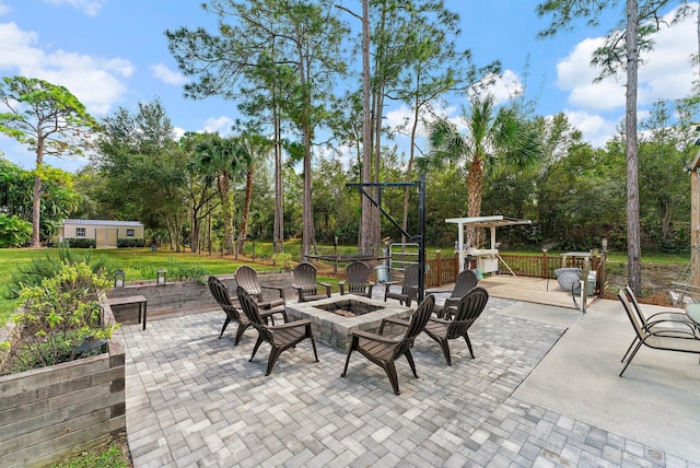 view of patio / terrace featuring a fire pit and a deck