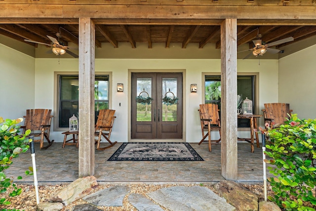 view of exterior entry with french doors and ceiling fan