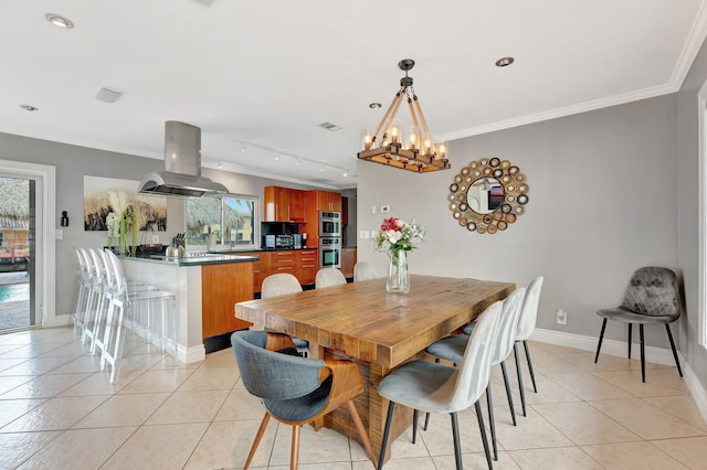 dining area with plenty of natural light, ornamental molding, and light tile patterned flooring