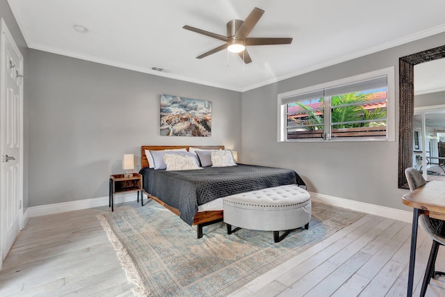 bedroom featuring ceiling fan, light hardwood / wood-style floors, and ornamental molding