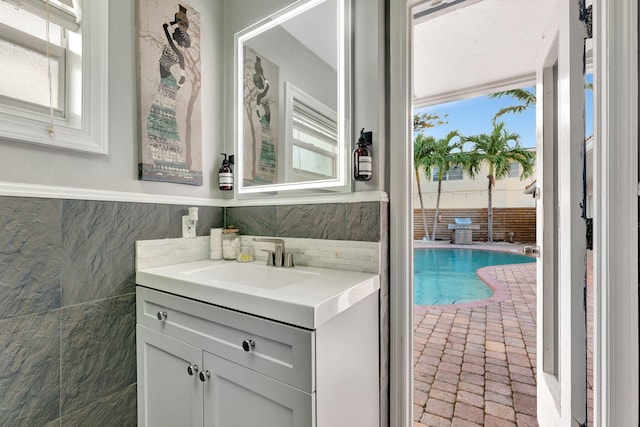 bathroom featuring a healthy amount of sunlight and tile walls