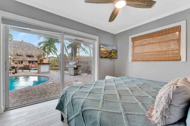 bedroom featuring hardwood / wood-style flooring, ornamental molding, access to outside, and multiple windows