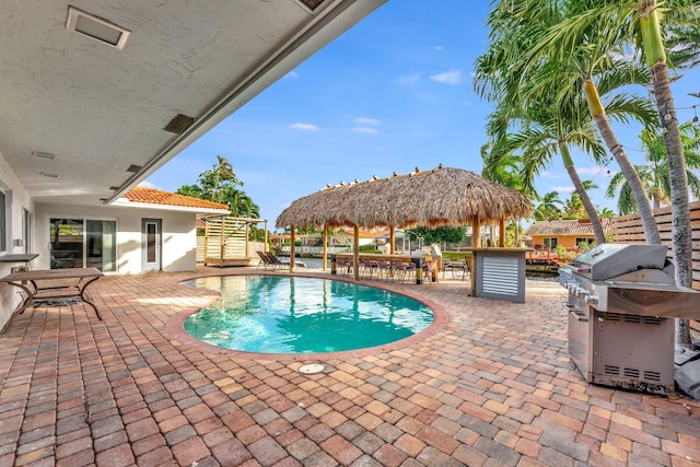 view of swimming pool featuring a gazebo, a patio, and area for grilling